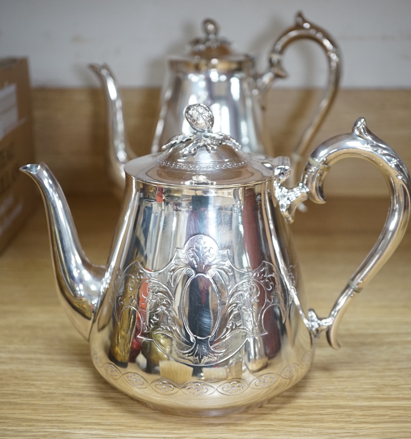 An Art Deco three piece silver brush set and a silver plated three piece tea set and miniature caldron, coffee pot 22cm high. Condition - fair